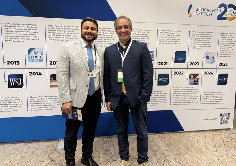 Milad Alucozai in front of Critical Path Institute's 20 year timeline